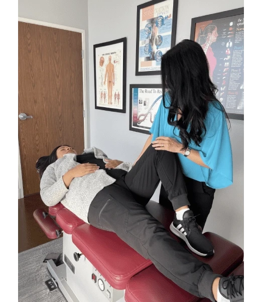 Chiropractor Valencia CA Carolyn Griffin Adjusting Patient