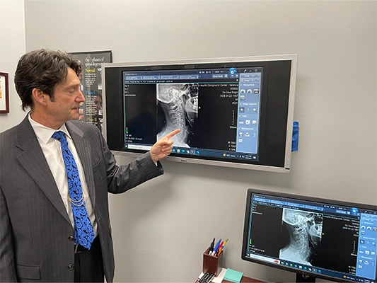 Chiropractor Valencia CA Roger De Sesa Pointing To Scan Results