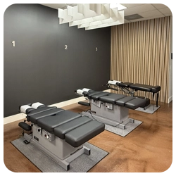 Three black adjustment tables in chiropractic office