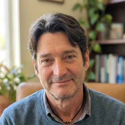 Man in blue sweater, smiling at camera